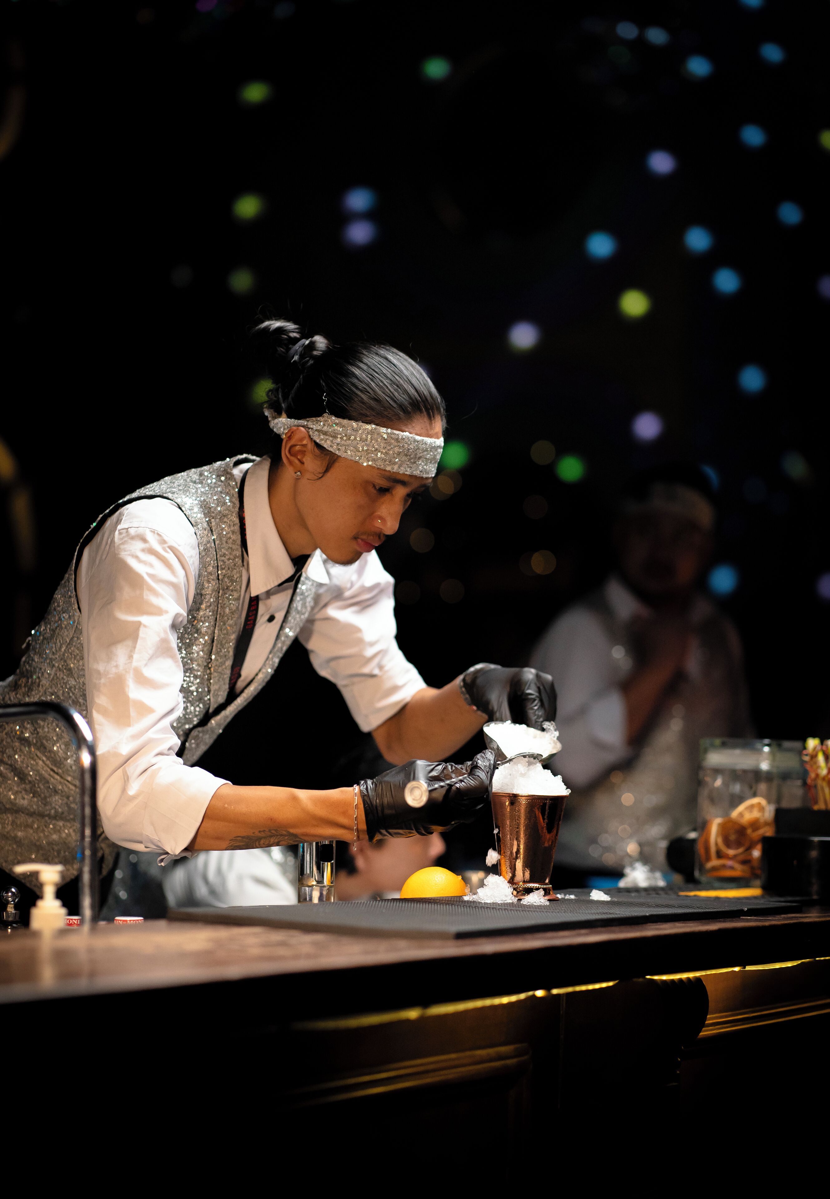 A bartender preparing a drink at a bar.