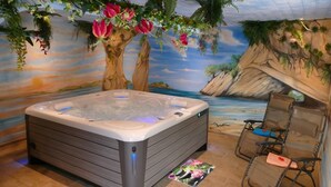 A hot tub in a room with a tropical mural, a chair, and a small mat. - 4-star vacation apartment "Sommerberg" incl. Schwarzatal guest card  (Rohrbach)
