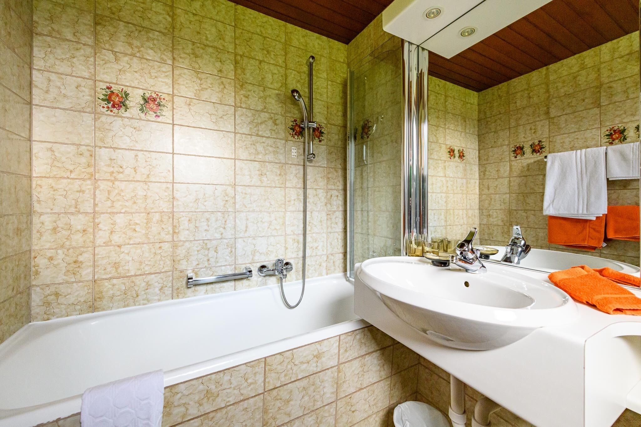 A bathroom with a bathtub, a sink, and a shower.