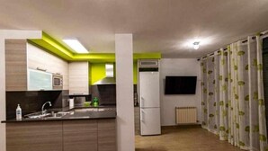A modern kitchen with a built-in oven, a sink, and a refrigerator. - Uncle Pepe House (Valderrobres)