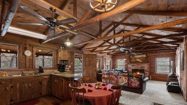 A rustic cabin interior with a dining area, kitchen, and living room. - 22 miles to Round Top, 3/2 w/ trailer parking, relaxing cozy cabin w/ lake, wifi (La Grange)