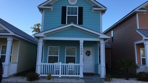 A two-story house with a front porch, a small front yard, and a mailbox. - 2-Bedroom Cottage, One Block to Beach! Free WIFI, Free Parking (Myrtle Beach)