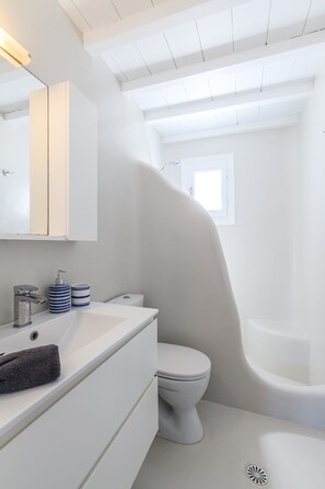 A modern bathroom with a white sink, toilet, and bathtub. - Cozy villa Amanda in Mykonos (Mykonos)