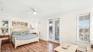 A bedroom with a bed, a ceiling fan, a table, and a window with blinds. - 9 Bedrooms / 6.5 Baths / Sleeps 28 / 8 Parking Spots / Pool / Steps to Beach!!! (Destin)