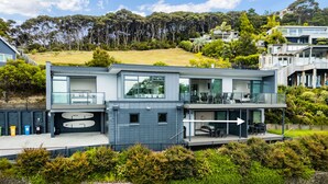 A modern two-story house with a balcony, a garage, and a well-maintained garden. - Bayview Corner Suite (Unit 2) - Paihia Unit (Paihia)