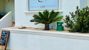 A building with a sign reading "Coco Beach Café" and the number "2612" on the wall. - 🏖️BEACHSIDE🏖️ 2/2 Condo In The Heartbeat of SPI!! (South Padre Island)