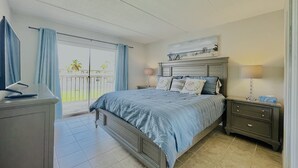 A bedroom with a bed, nightstands, a desk, and a window with curtains. - 🏖️BEACHSIDE🏖️ 2/2 Condo In The Heartbeat of SPI!! (South Padre Island)