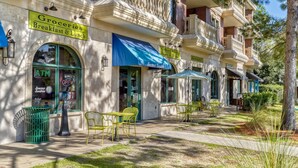 A building with a sign for a grocery store and a coffee shop. - Newly Renovated Professionally Decorated Gulf Views! Pool & Beach Access. (Seacrest Beach)