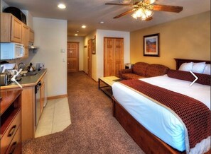 Relax in this inviting space with a large bed, kitchenette, and comfortable seating area.