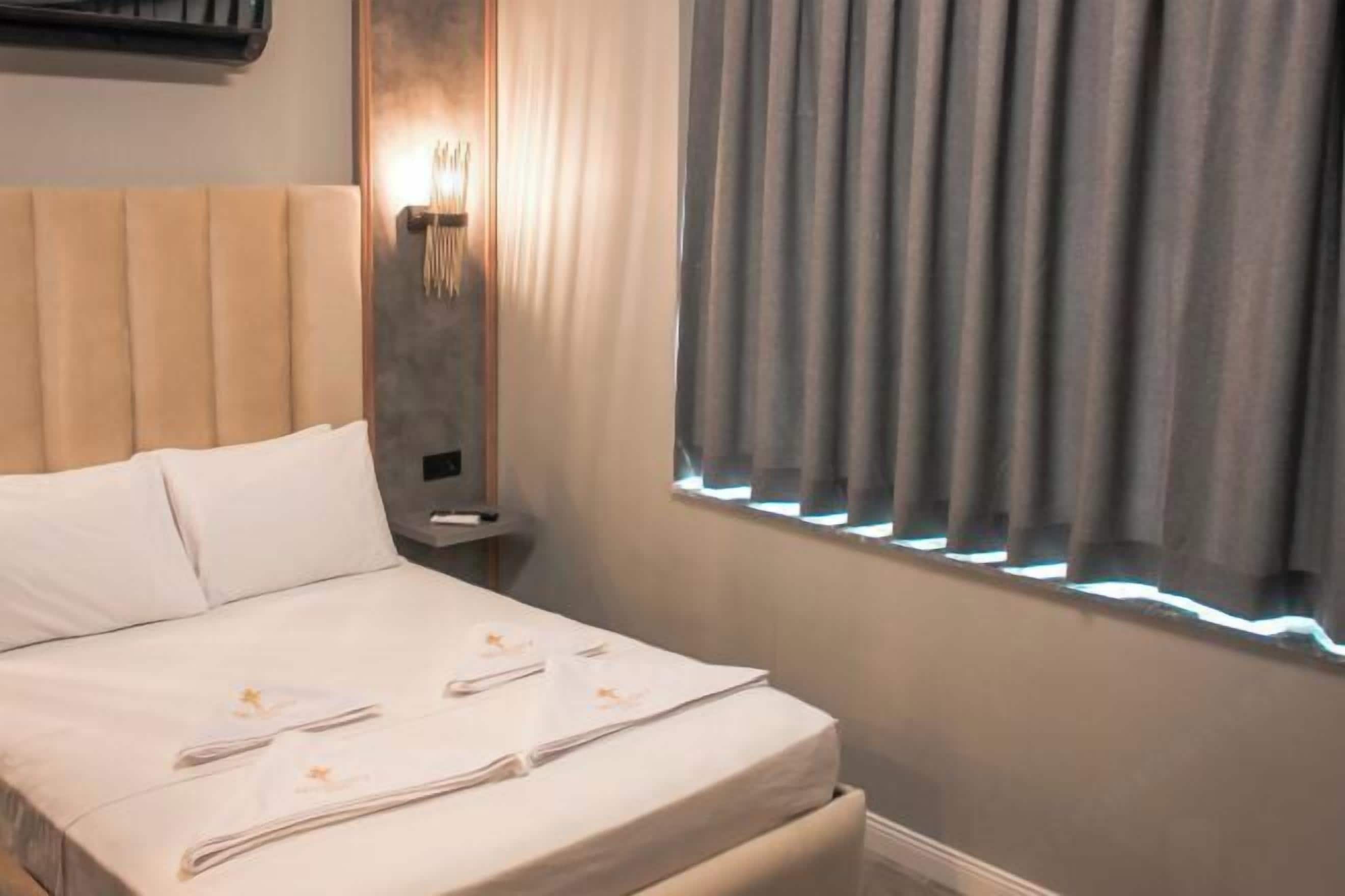 Laptop workspace, blackout drapes, iron/ironing board, bed sheets