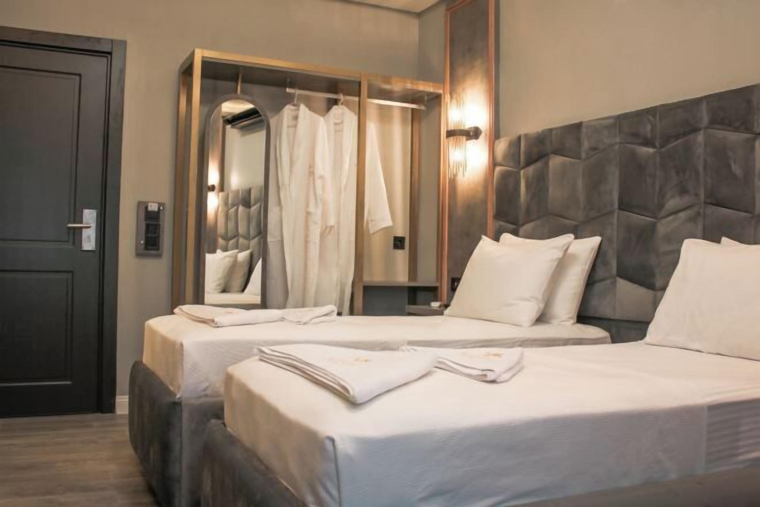 Laptop workspace, blackout drapes, iron/ironing board, bed sheets