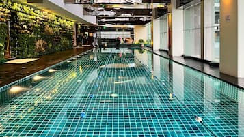 Relax by the pool surrounded by lush greenery and enjoy the modern architecture.