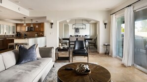 A modern living room with a sofa, coffee table, and dining area. - Sparkling Pool, Poker Table, and Relaxation at Sweetwater (Scottsdale)