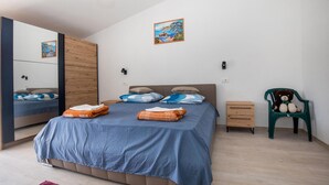 A bedroom with a bed, a dresser, a chair, and a mirror. - Amazing home in Peracko Blato (Peracko Blato)