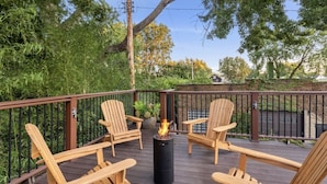 A wooden deck with four Adirondack chairs and a central fire pit. - Over 4500 sqft of Luxury living [Billiards table, Arcade room, 5 BR & 4 BA] (Cleveland)