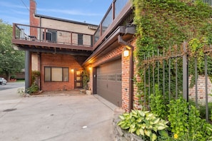 Taken from next to the back garden, we have the spacious 2.5 car garage, a shot of the patio area, and the gorgeous ivy growing along the side.  - Westside Warehouse-Hot Tub/GameRM/PoolTable & More (Cleveland)