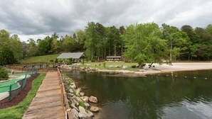 A lakeside resort with a wooden deck, picnic tables, and a gazebo. - Pet Friendly, Resort Access, Private! - Catahoula Cabin by Carolina Properties (Lake Lure)