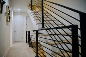 Stairs lead to an upper level with a door at the bottom.