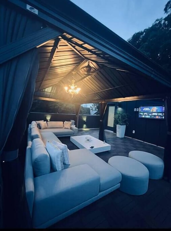 Relax in a spacious lounge area with a curved ceiling, sectional sofa, and comfortable seating.