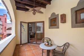 Enjoy a peaceful retreat on this balcony with a table and chair, perfect for taking in the city views.