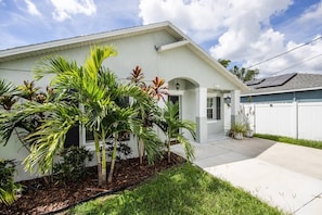 Stunning single-story residence with a flat roof and lush tropical garden.