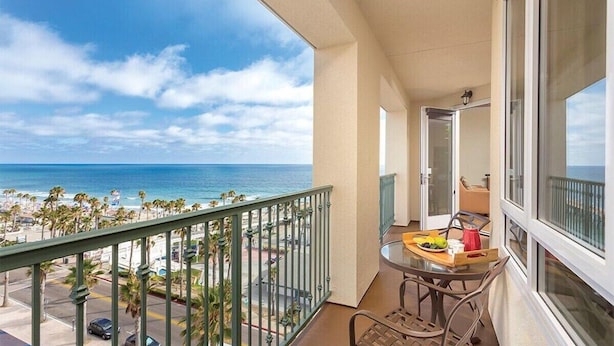 A balcony with a view of the beach and ocean. - Club Wyndham Resort 3 Bedroom Presidential Ocean View (Oceanside)