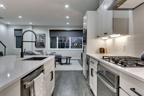 Kitchen including gas range, oven, wine fridge and dishwasher