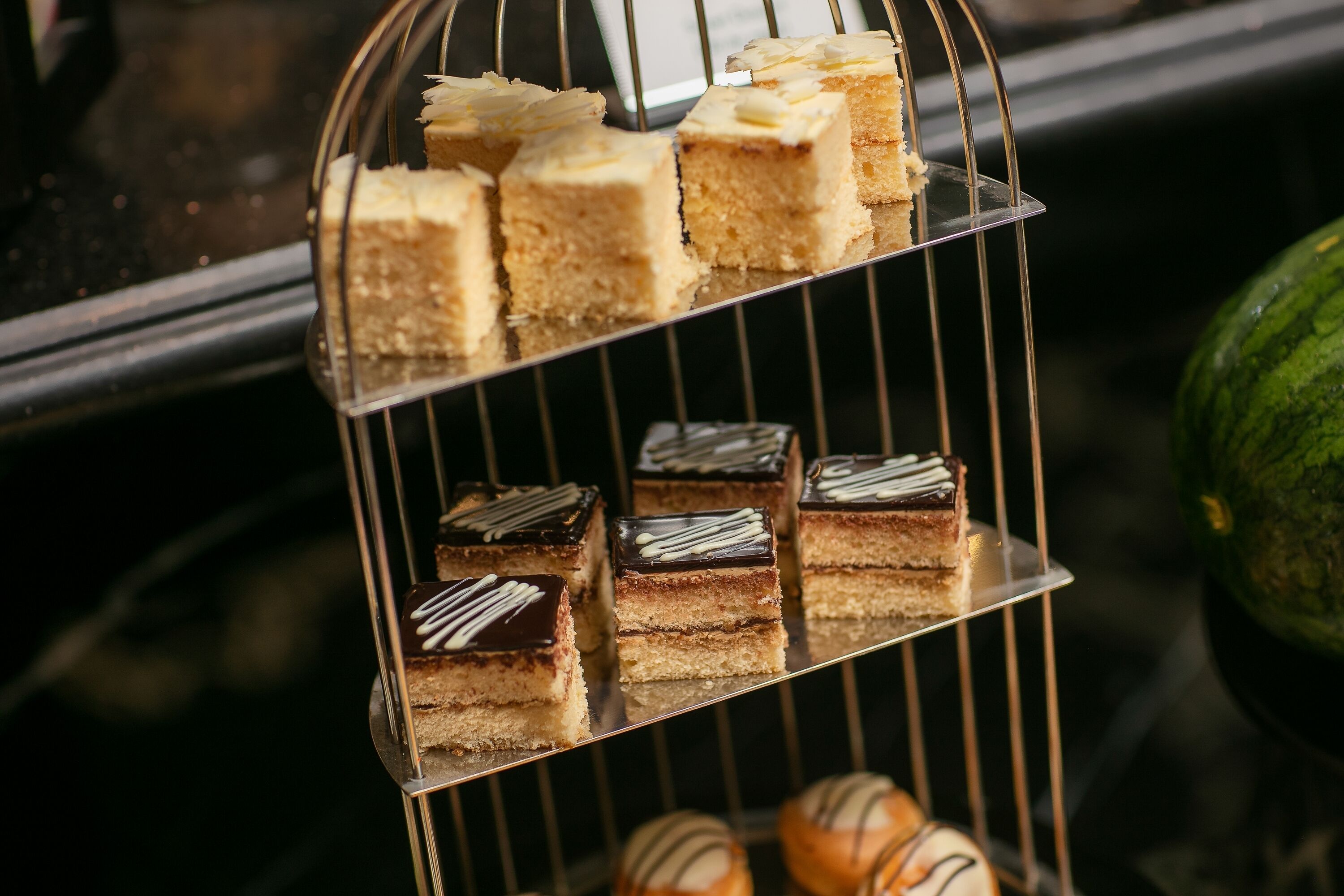 A tiered dessert display with various cakes and pastries.
