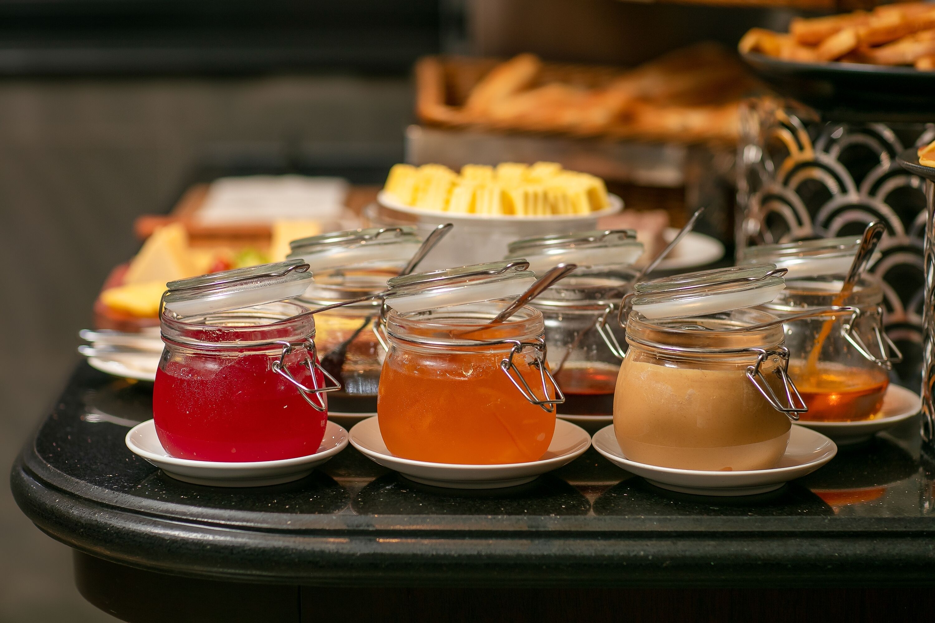 A buffet table with various food items and beverages.