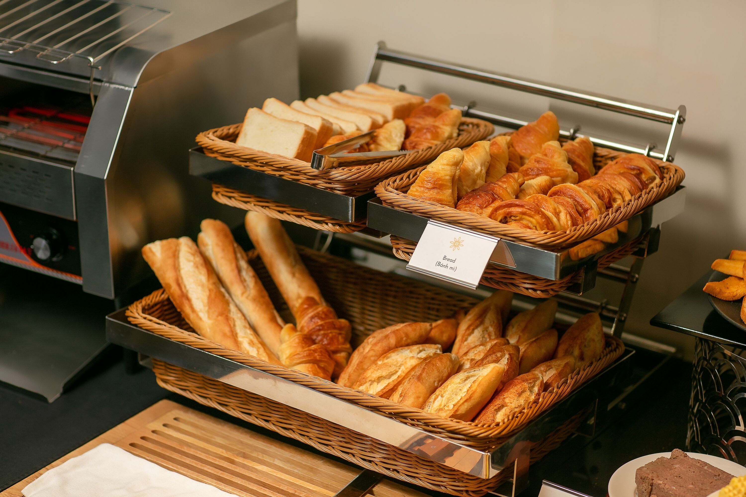 A bakery display with various types of bread and pastries.