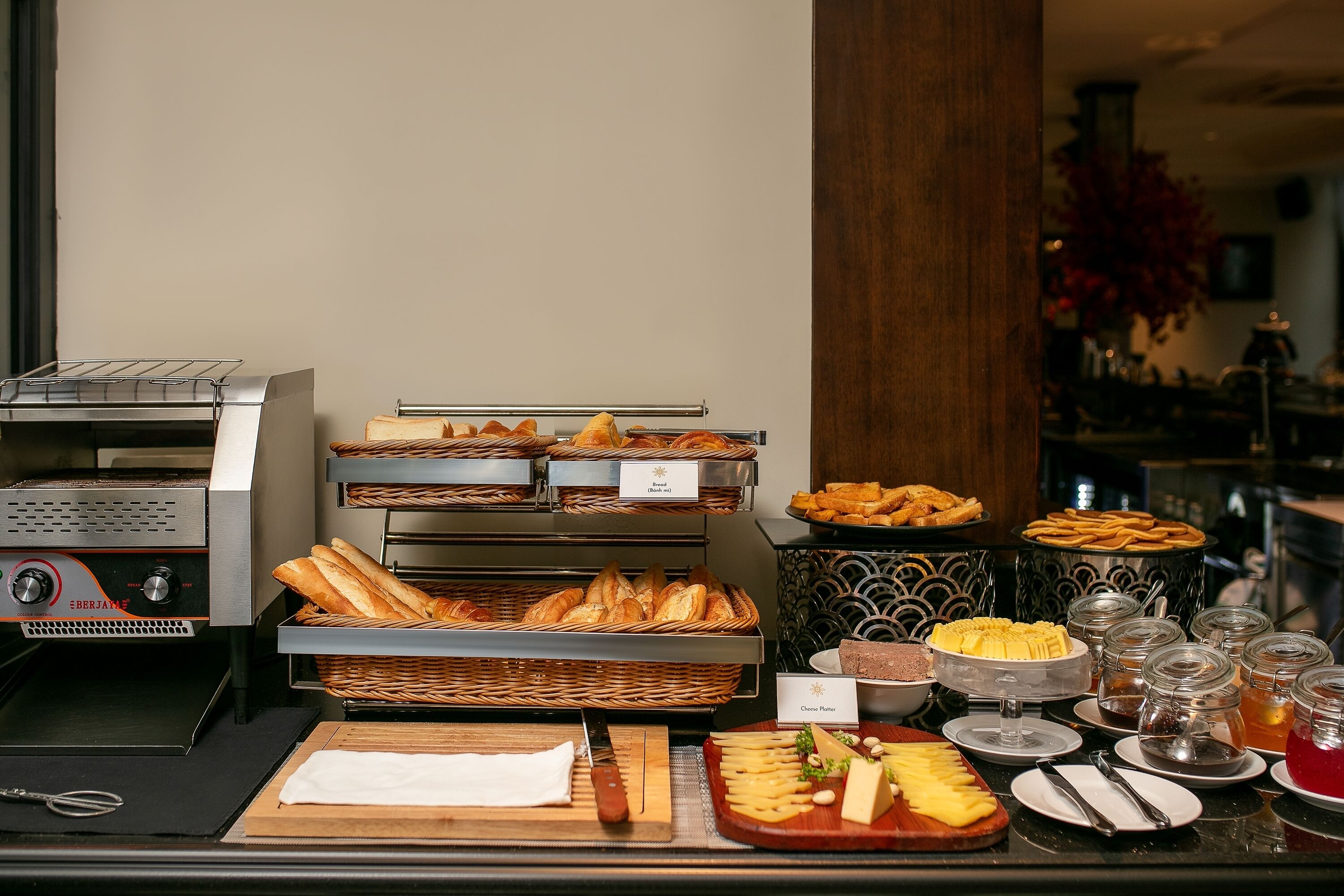 A buffet with various food items, including bread, cheese, and pastries.
