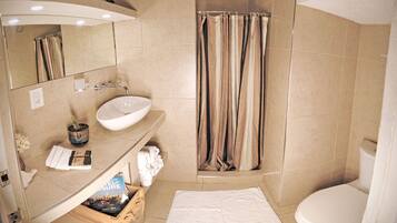 A modern bathroom with a sink, mirror, and shower curtain.