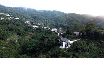 A hillside village with traditional houses and a modern building with a flat roof.