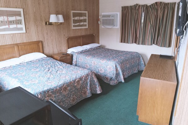 A hotel room with two beds, a desk, a dresser, and a TV. - Blue Way Inn And Suites Winfield (Winfield)