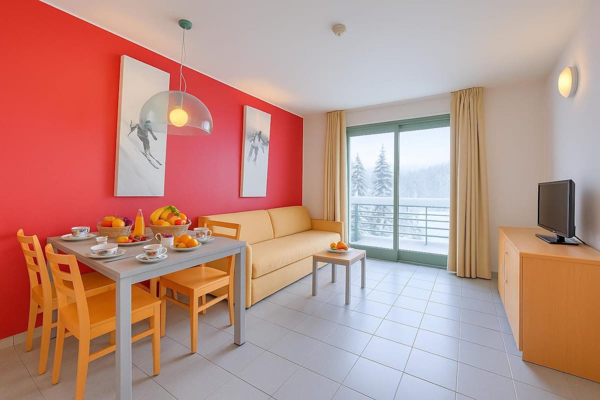 Family Apartment, 1 Bedroom (Teleo 83 Ski In - Ski Out 50m) | Living area | 21-inch flat-screen TV with cable channels, TV