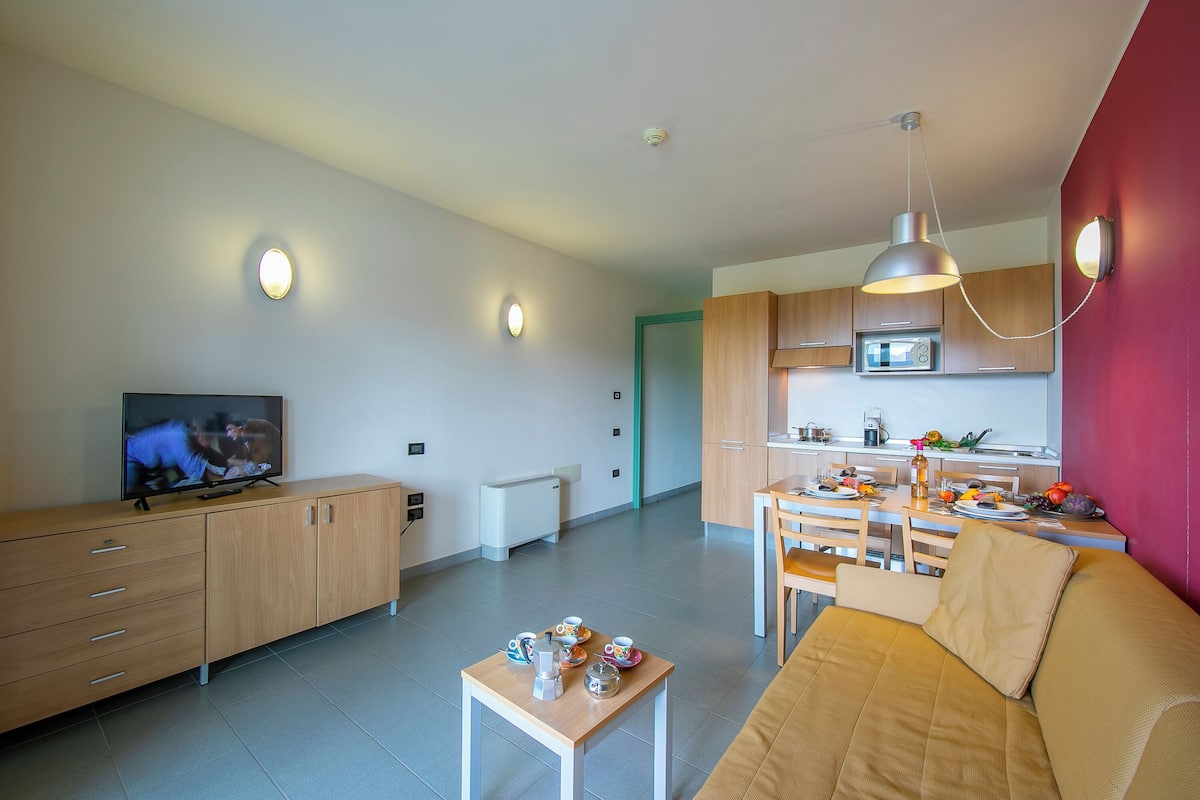 Family Apartment, 1 Bedroom (Teleo 115 Ski In - Ski Out 50m) | Living area | 21-inch flat-screen TV with cable channels, TV