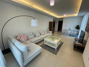 Apartment, 2 Bedrooms, Partial Sea View, Tower | Living area | 55-inch TV with cable channels - VB22 & VB23 by Qatar Coral (Doha)