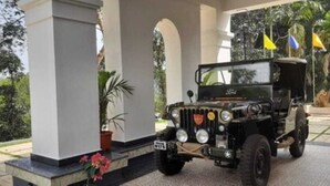 A black off-road vehicle parked under a covered area with columns and potted plants. - Orange Valley Plantation Holiday Resort Coorg (Virajpet)