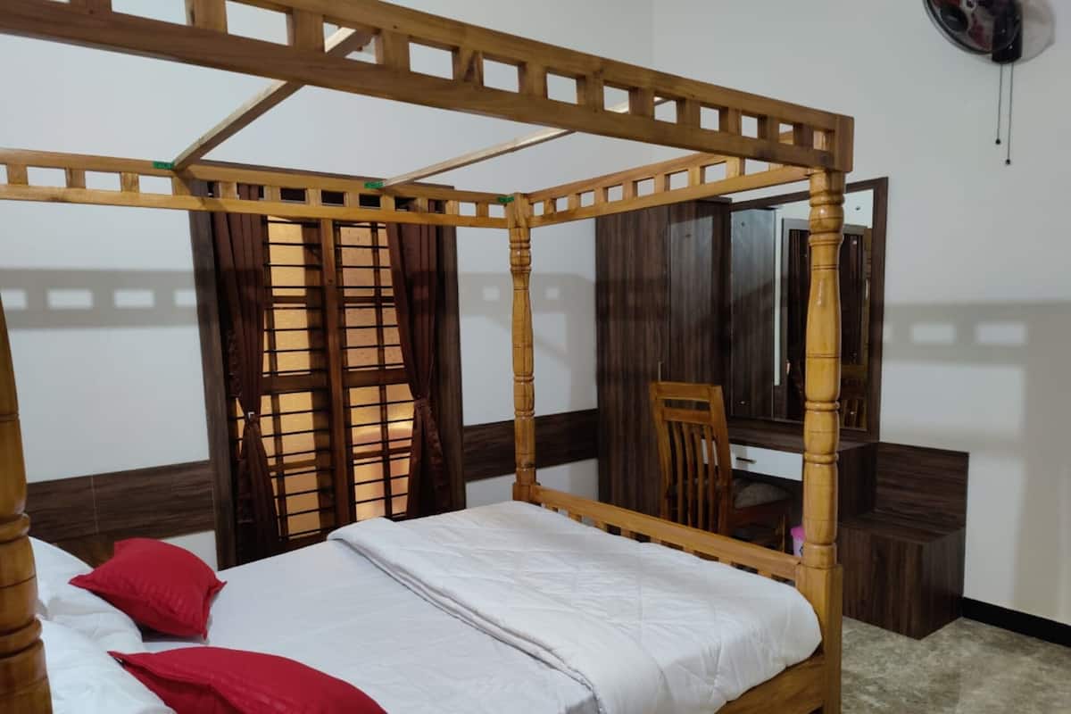 Un lit à baldaquin avec un cadre en bois, un miroir et une chaise en bois, dans une pièce dont le sol est recouvert de carreaux.
