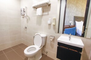 A bathroom with a toilet, sink, and shower. - CitiVilla Penang (George Town)