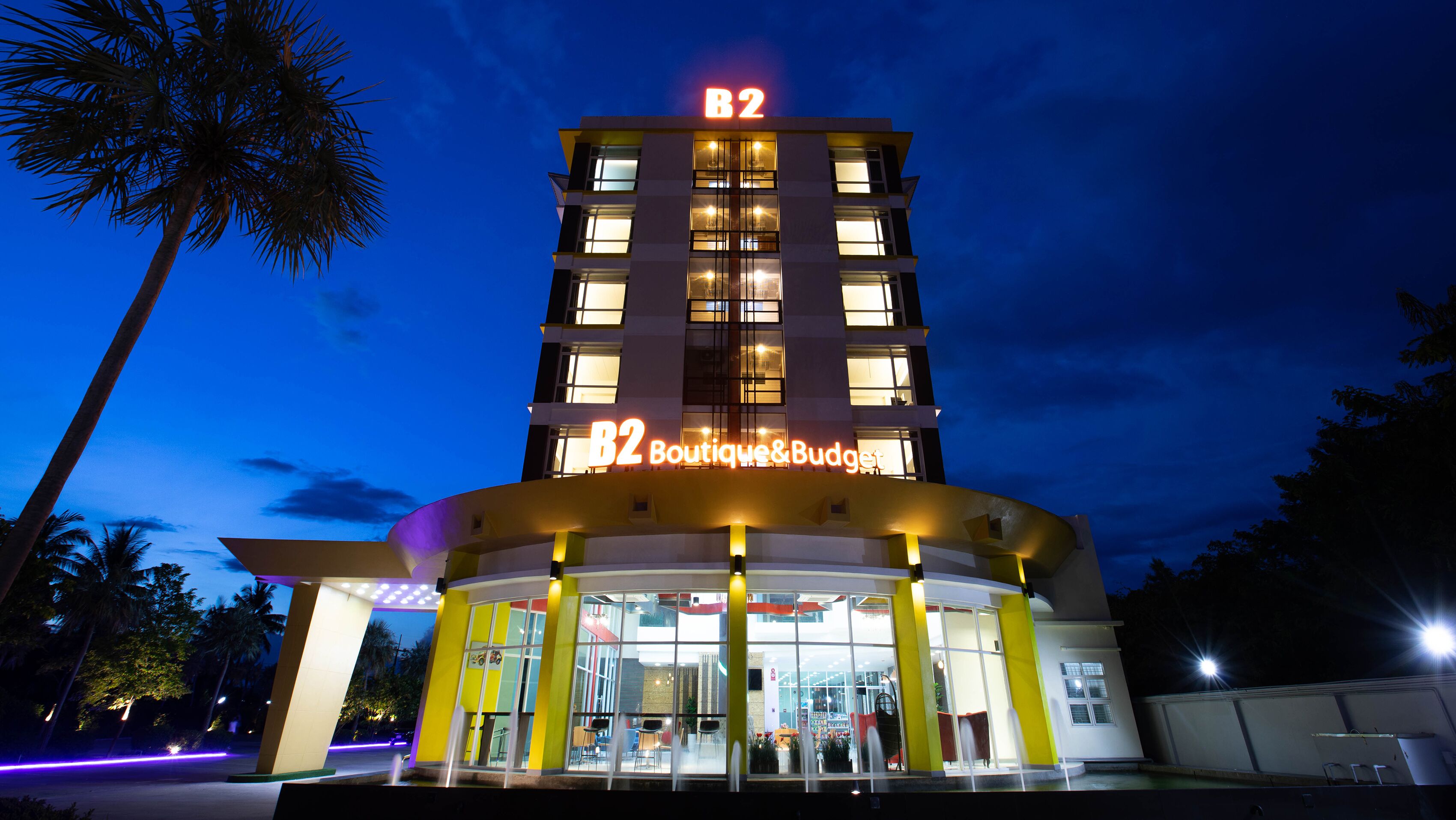 A multi-story hotel with a prominent 'B2 Boutique & Budget' sign at the entrance.