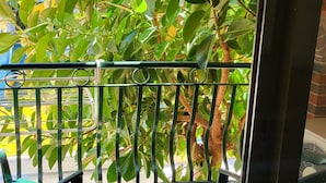 A balcony with a tiled floor, a metal railing, and two green chairs. - MAXWELL HOLIDAY CLUB (Marmaris)