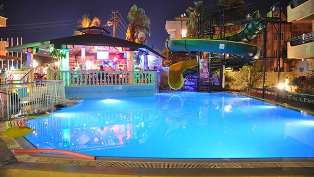 A swimming pool with a water slide and a bar area. - MAXWELL HOLIDAY CLUB (Marmaris)