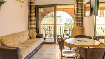 Standard Apartment | Living area | 54-inch LCD TV with satellite channels, TV