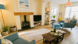 A cozy living room with a fireplace, a television, and comfortable seating.