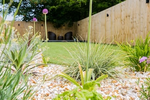 Stroll through the serene garden, surrounded by lush plants and a tranquil atmosphere.