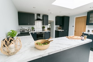 Enjoy cooking in this well-lit kitchen with a central island and oven.
