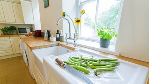 A kitchen with a sink, a window, and a countertop with various items.