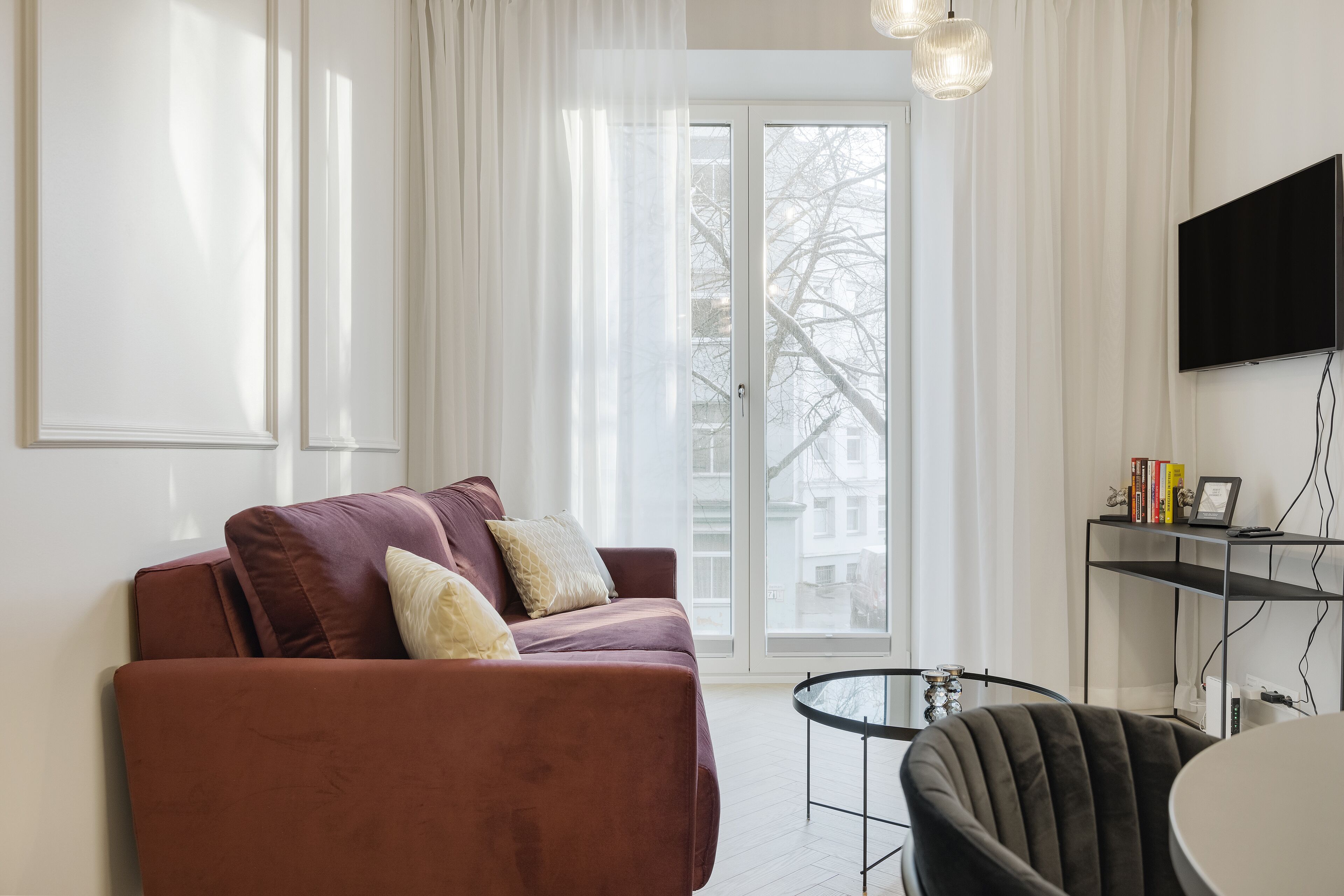 Roomy Apartment | 1 Bedroom | Living area | 42-inch flat-screen TV with cable channels, TV, video-game console