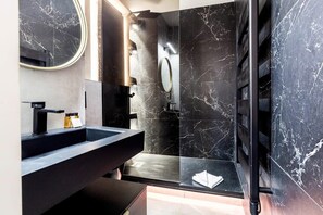 Shower, hair dryer, towels, shampoo